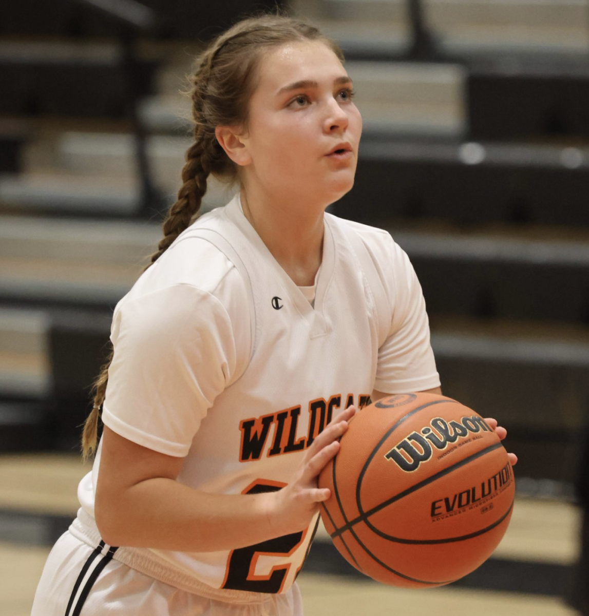 Girls varsity basketball player prepares for a free throw in the game.